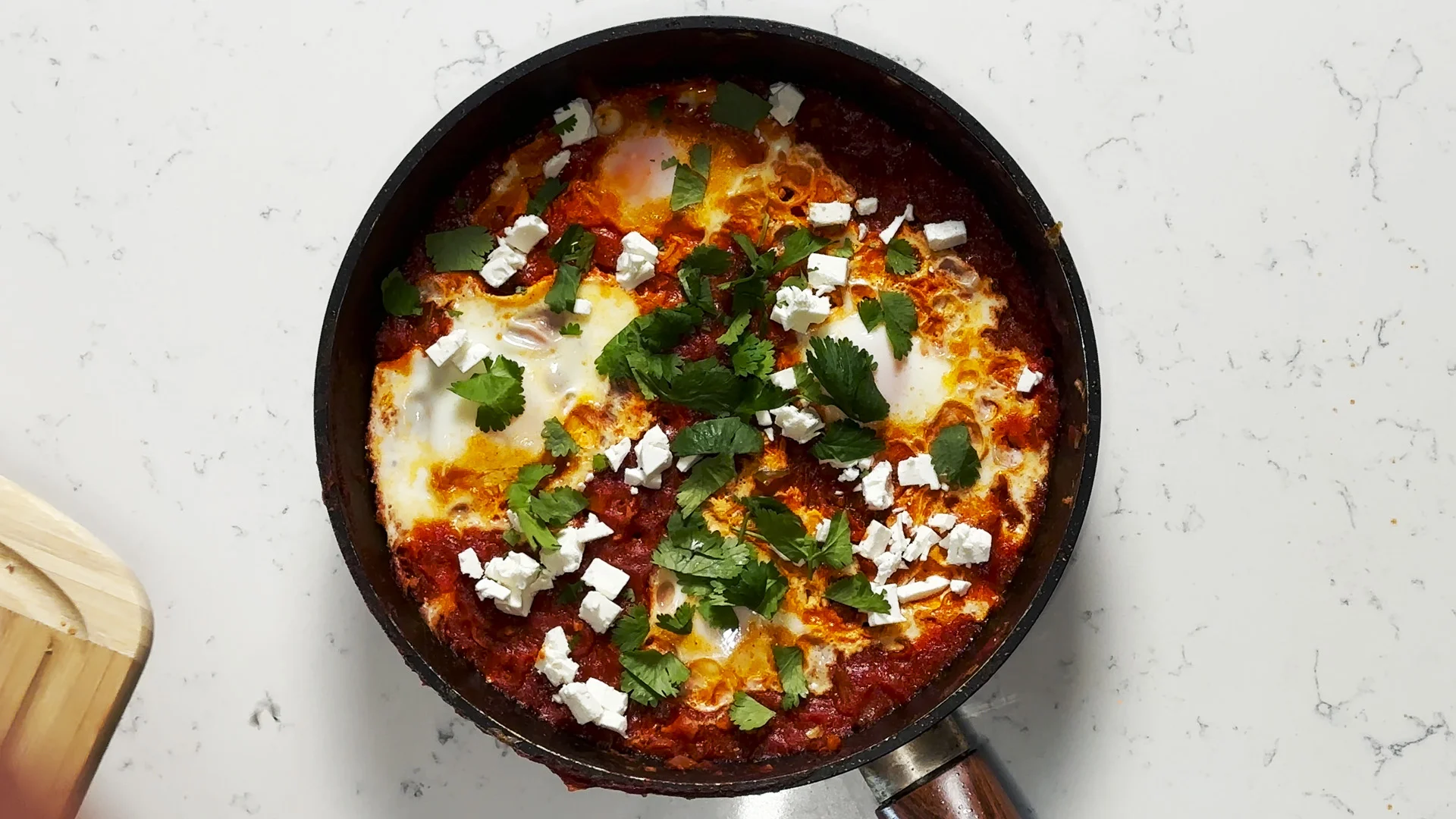 Shakshuka in a skillet on a countertop.