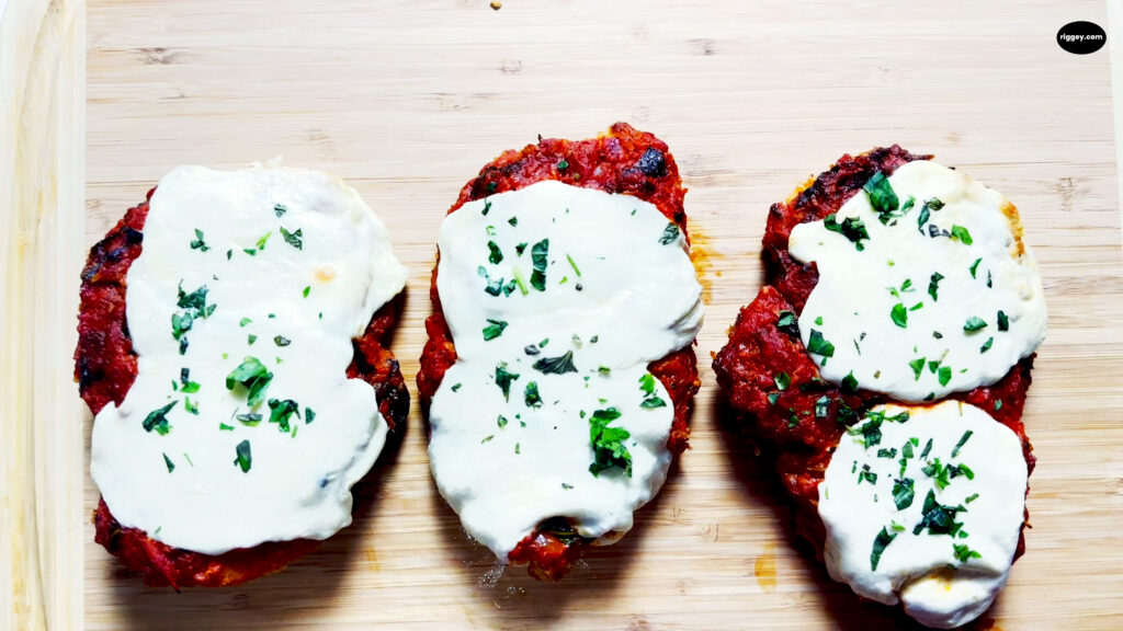 Chicken Parmesan on cutting board.